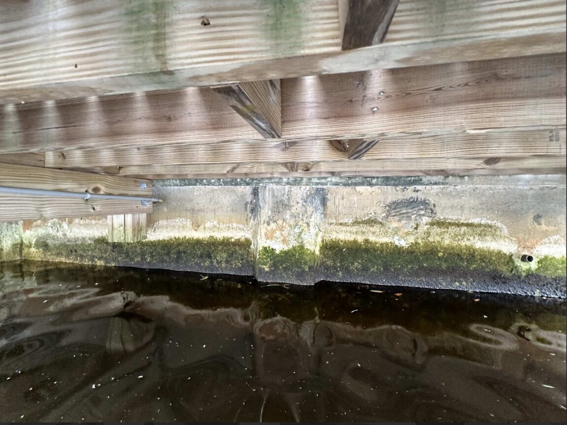 Corroded and rusted seawall tie-back rod hardware identified during a licensed structural engineer seawall inspection in Florida